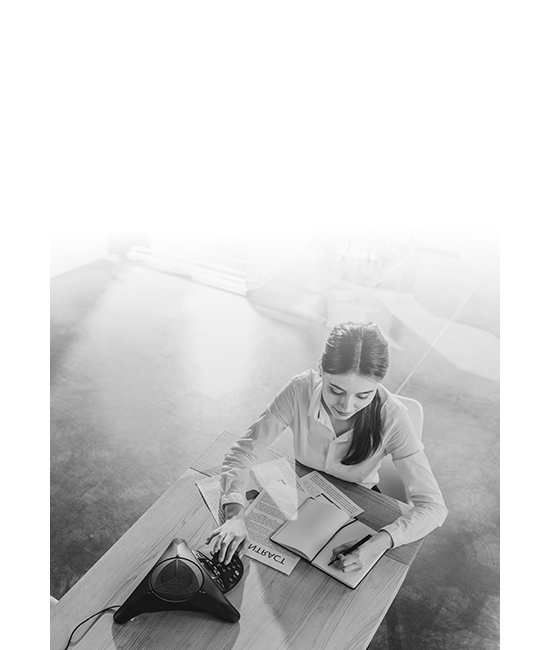 A woman making a business call from her desk