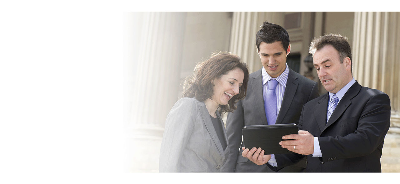 Three goverment employees working together on a tablet.