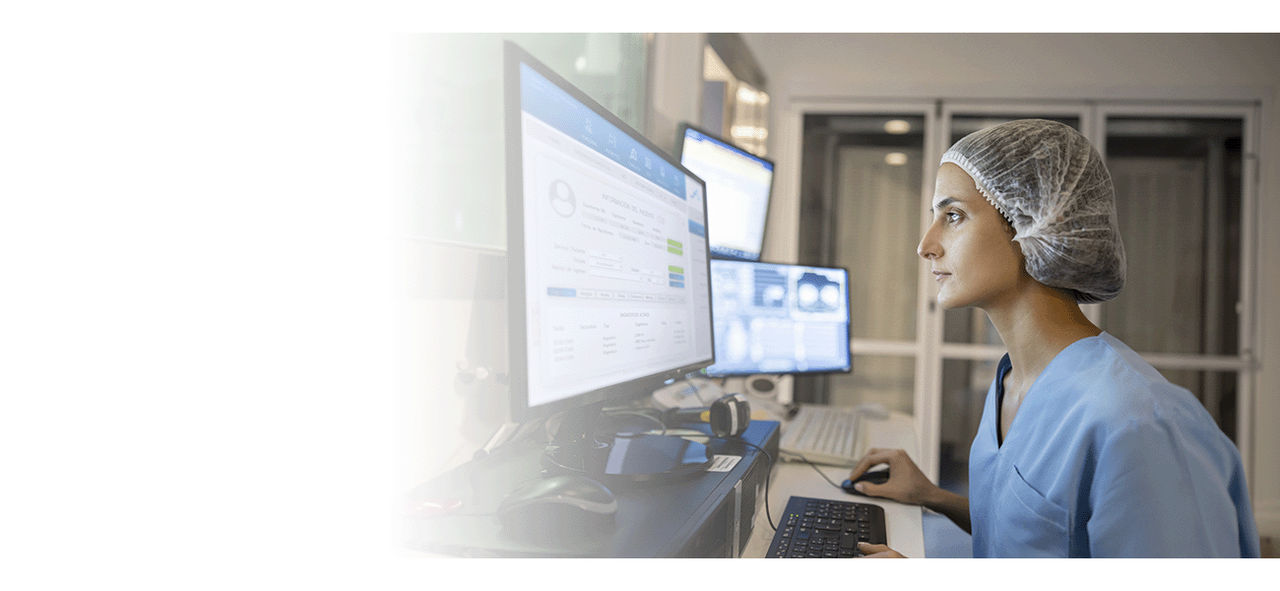 A nurse looking up patient data on her desktop