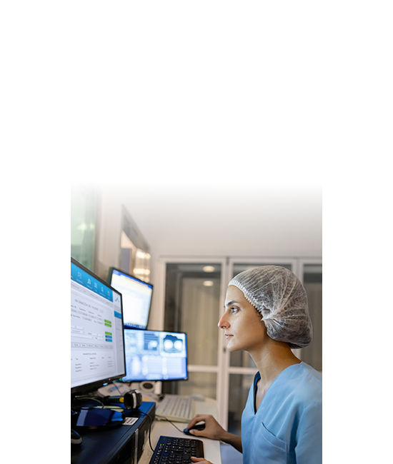 A nurse looking up patient data on her desktop